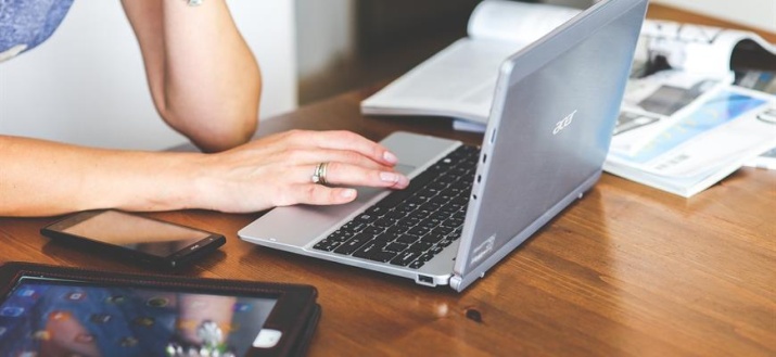 Person sitting in front of an open laptop.