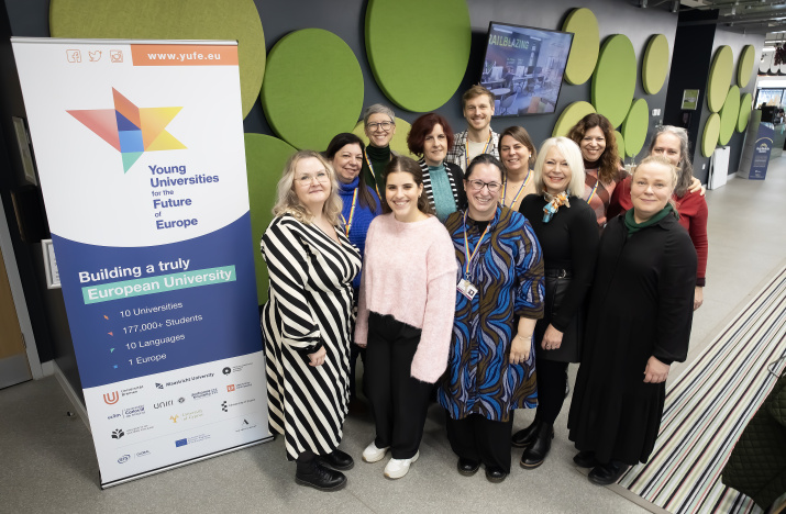 12 members of the YUFE ED&I Work Package pose for a photo next to a banner titled 'Young Universities for the Future of Europe' at University of Essex's Colchester campus.