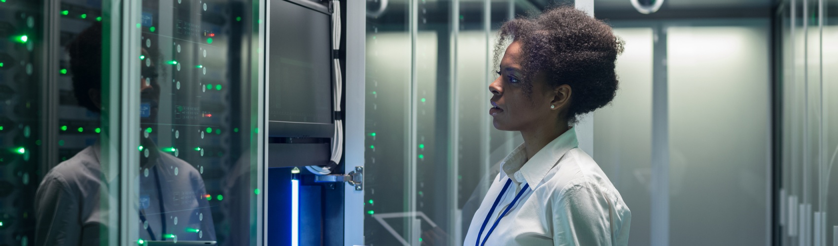 Female technician works on a tablet in a data center