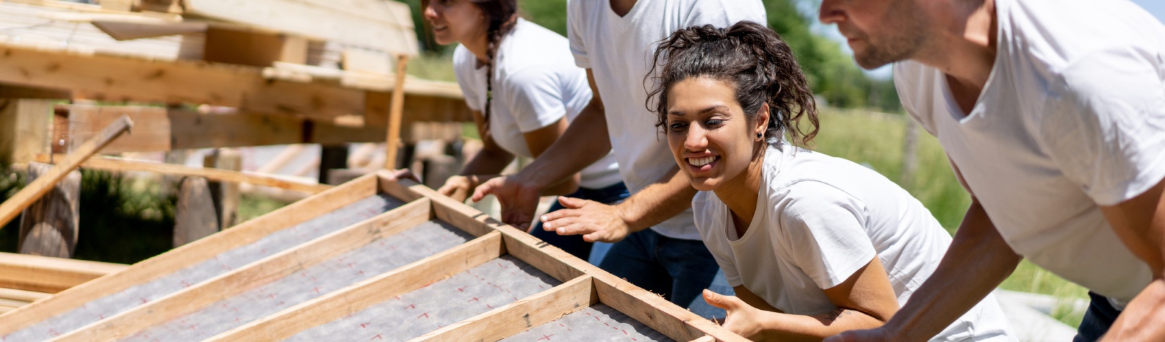 Latin american volunteers working hard at a charity construction project