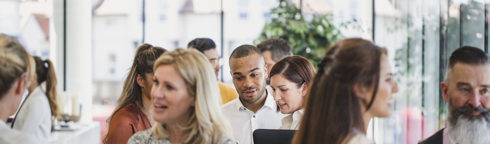 Work colleagues meeting and talking in corporate building