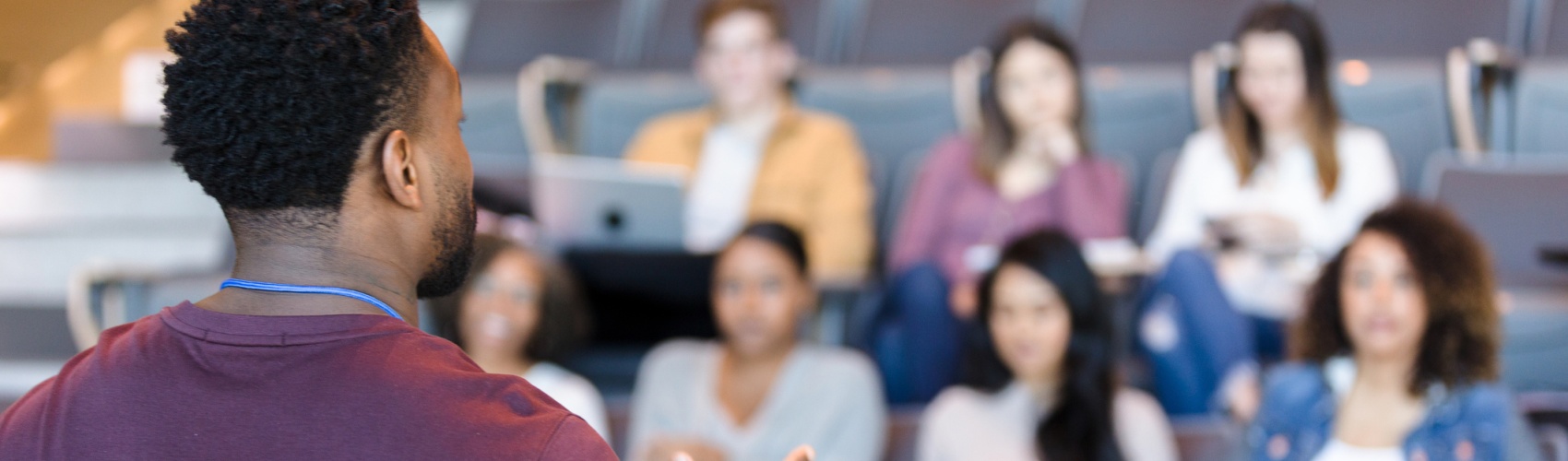 Male college professor gestures during lecture