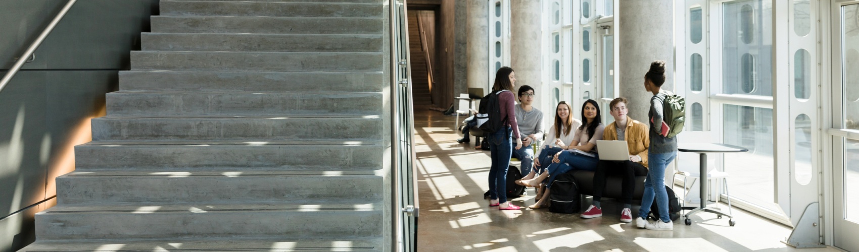 College students descend indoor staircase