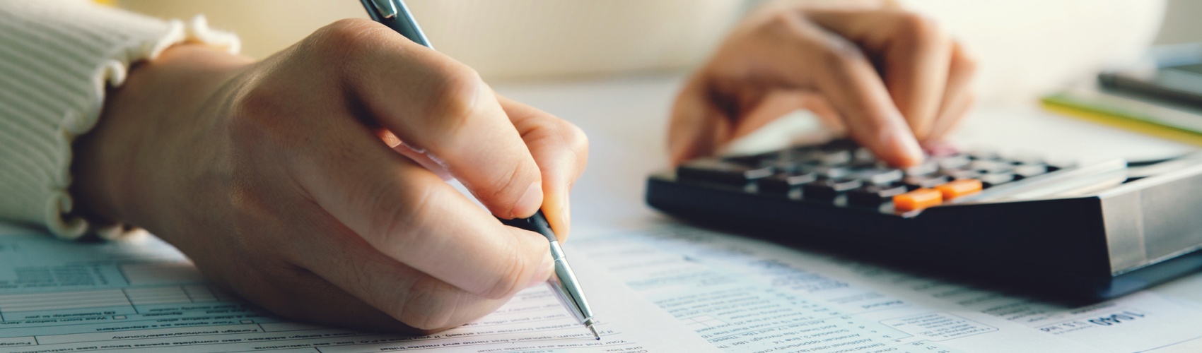 Closeup woman filling form of Individual Income Tax Return