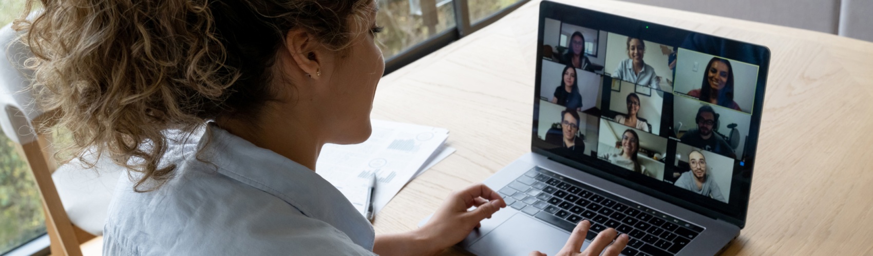 Woman in a video conference with her coworkers while working from home