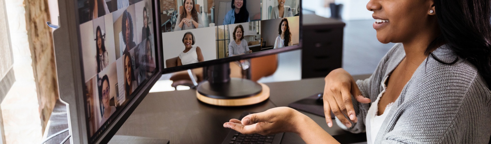 During COVID-19, attractive woman gestures during virtual meeting with colleagues