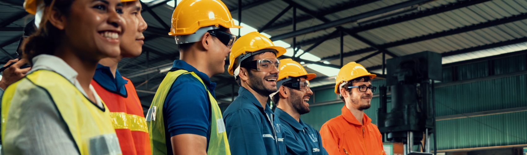 Skilful workers attending brief meeting in the factory