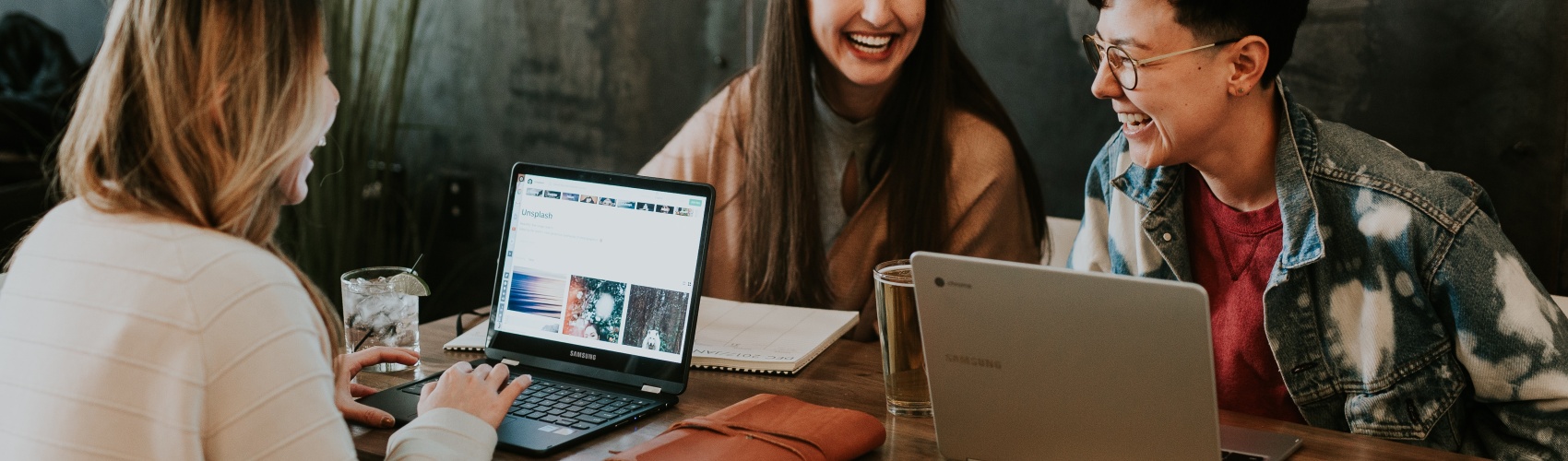 Students laugh at a laptop