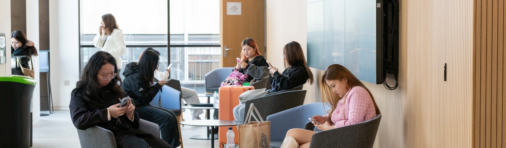 International students relax in the lobby of a university building