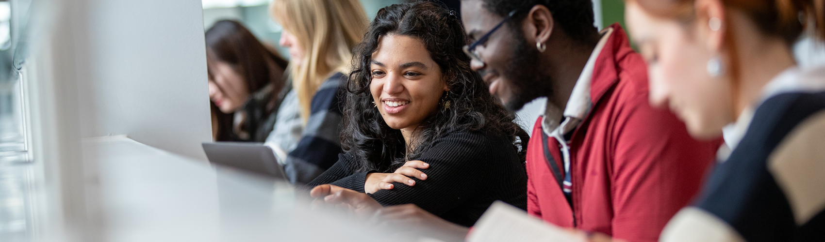 Students work together in a modern library at Durham University.