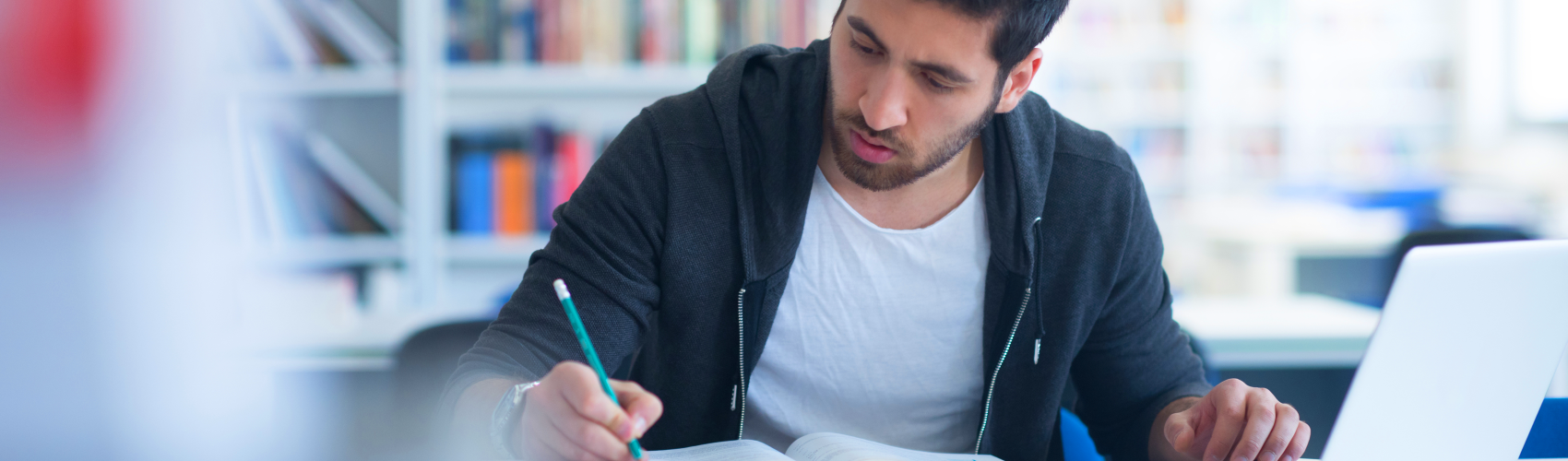 Man doing university work in a library