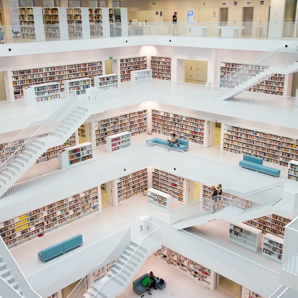 Wide shot of library with multiple books and staircases.
