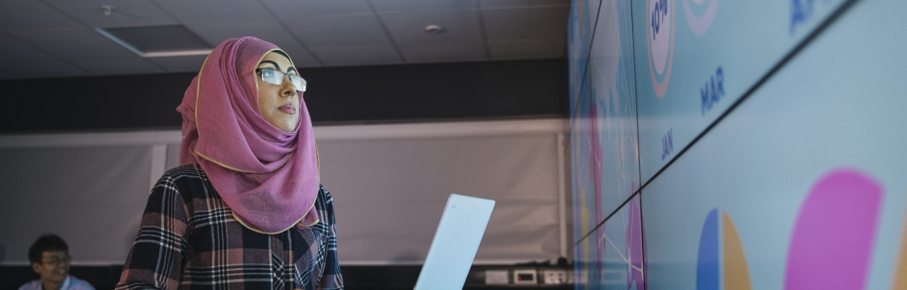 Young Woman Programming a Data Presentation