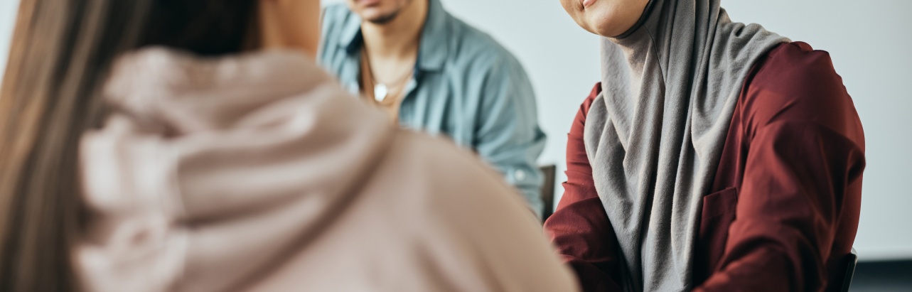 Muslim woman supporting someone during talk therapy