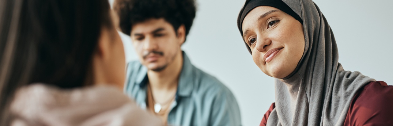 Muslim woman supporting someone during talk therapy