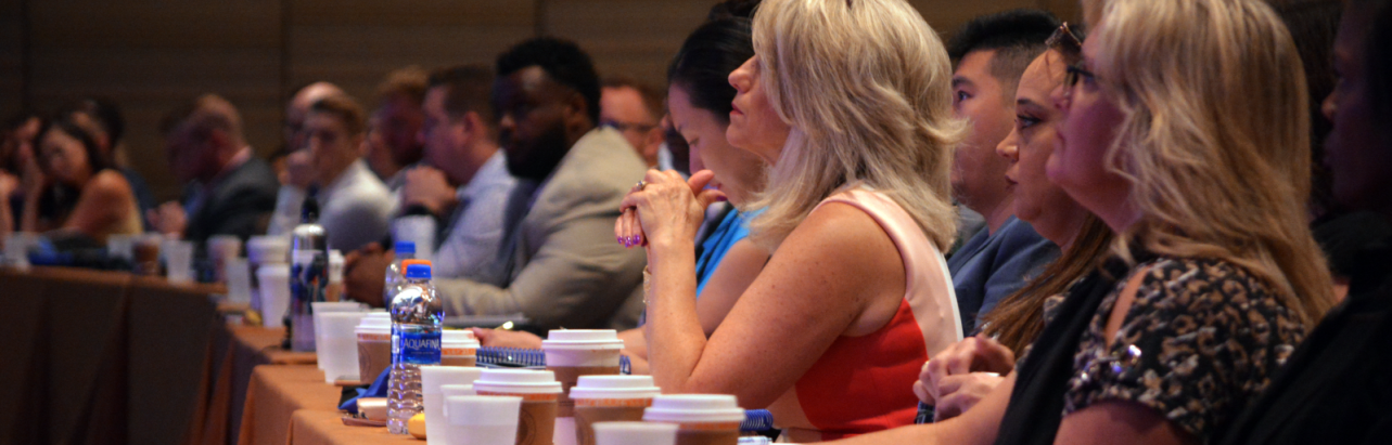 a long table with attendees at a conference