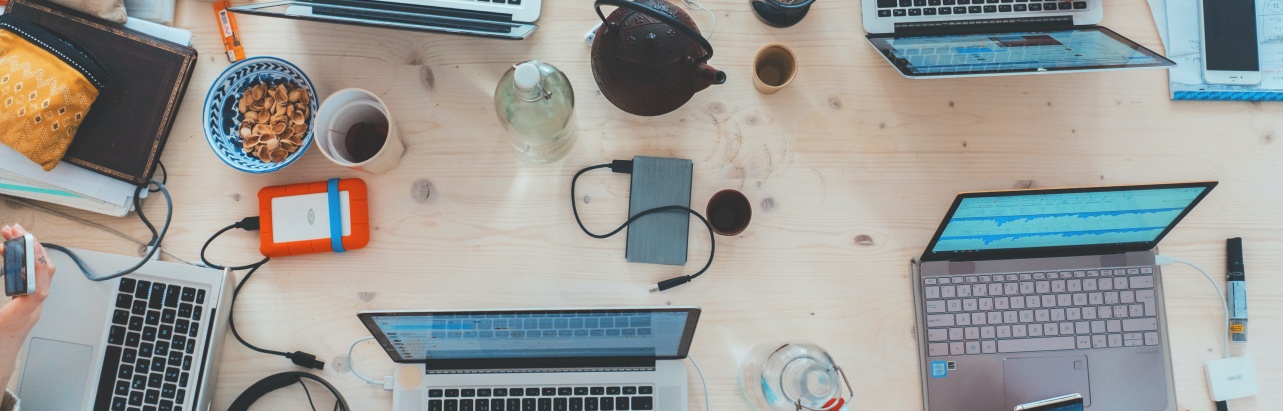 image of multiple laptops in a workspace 