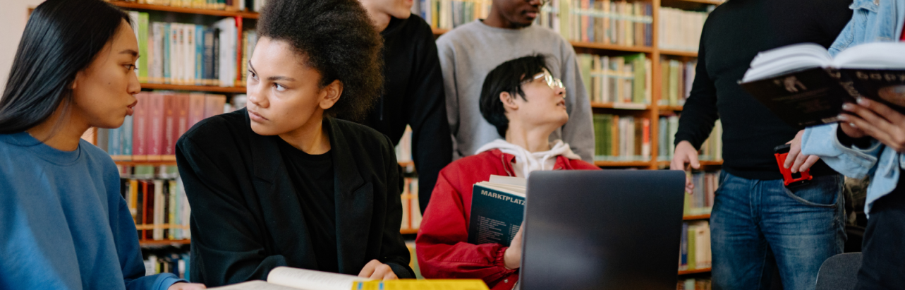 Students collaborating under the supervision of a teacher