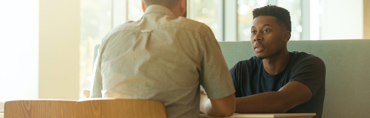 Two men talking in a café