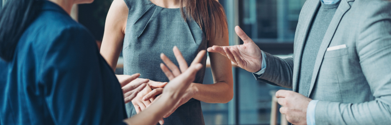 people talking in a circle gesticulating 