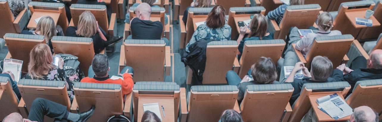 Students sat in a busy lecture theatre