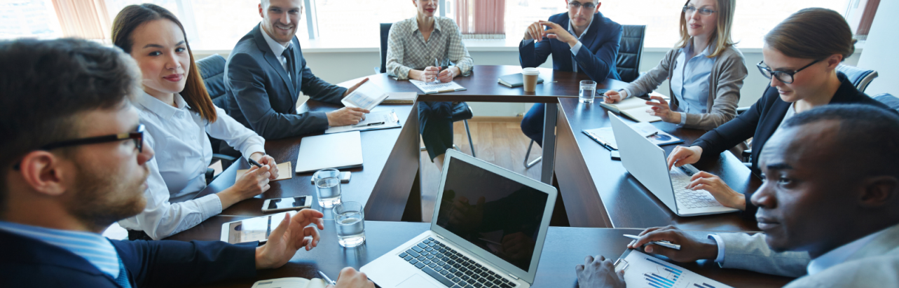 A group of professionals discussion around at the table