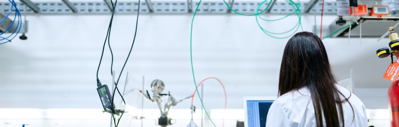 A person facing a screen in a laboratory