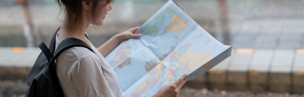 a girl holding a world's map