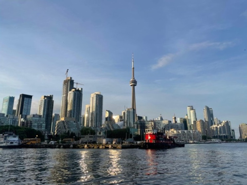 Toronto skyline, featuring the CN Tower, skyscrapers, and water in the forground