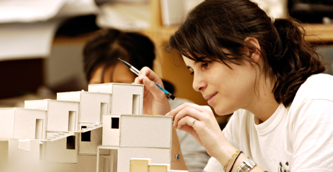 A female design student works on an architectural model 